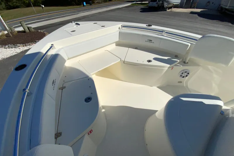 Slide: The Image of 2026 Cobia 220 Center Console boat interior with seating and storage compartments. - 20