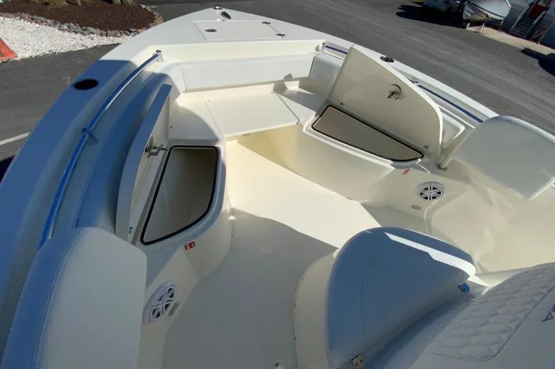 Slide: The Image of 2026 Cobia 220 Center Console boat interior with open storage compartments. - 21