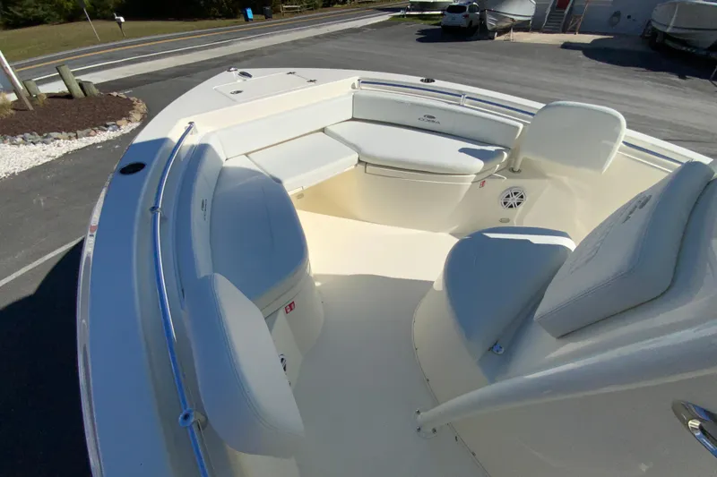 Slide: The Image of 2026 Cobia 220 Center Console boat interior with cushioned seating and sleek design. - 22