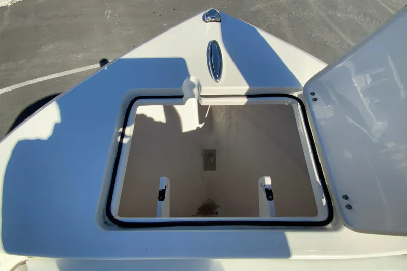 Slide: The Image of Open storage compartment on 2026 Cobia 220 Center Console boat. - 25