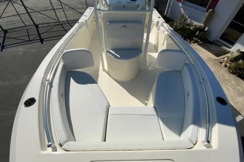 Slide: The Image of 2026 Cobia 220 Center Console boat with spacious seating and sleek design. - 26