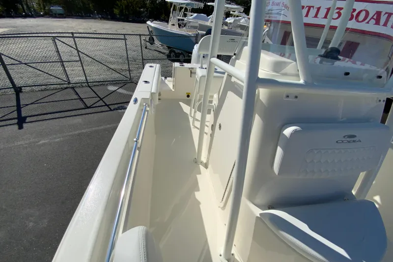 Slide: The Image of 2026 Cobia 220 Center Console boat interior with seating and console view. - 29