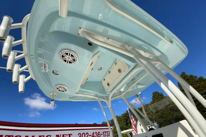 Slide: The Image of 2026 Cobia 220 Center Console boat underside with speakers and rod holders. - 31
