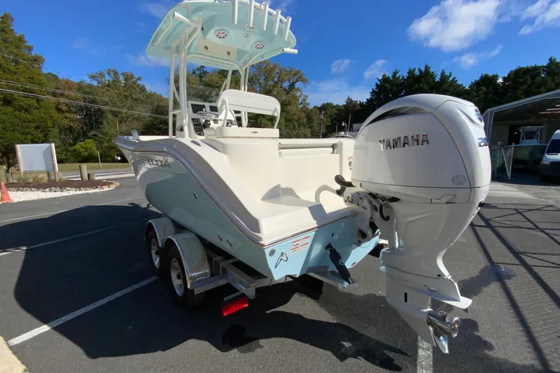 Slide: The Image of 2026 Cobia 220 Center Console boat with Yamaha engine on trailer. - 7