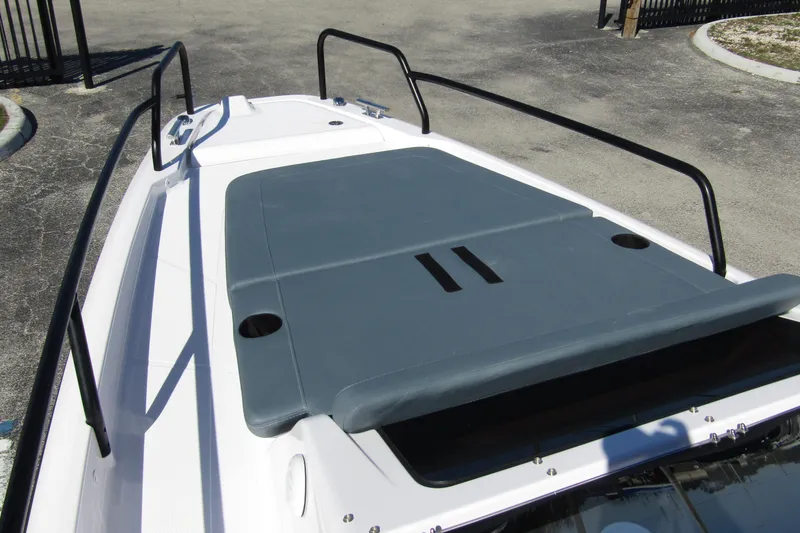 Slide: The Image of 2024 Axopar 25 Cross Top boat deck with cushioned seating and railings. - 10