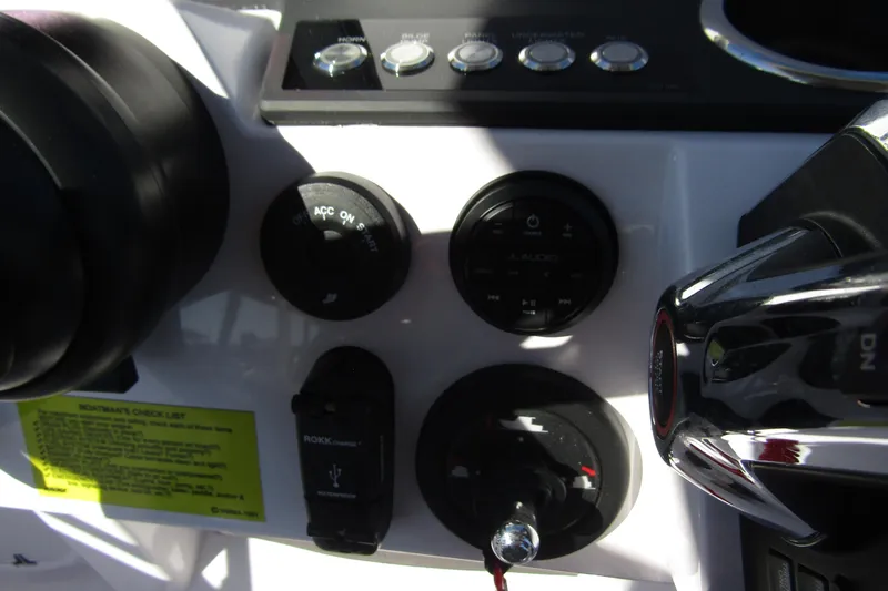 Slide: The Image of Control panel of 2024 Axopar 25 Cross Top boat with switches and dials. - 16