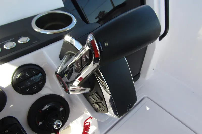 Slide: The Image of Close-up of 2024 Axopar 25 Cross Top boat controls and dashboard. - 17