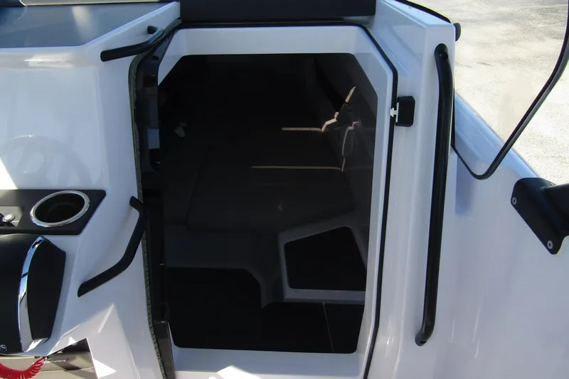 Slide: The Image of 2024 Axopar 25 Cross Top cabin entrance with sleek design and modern features. - 18