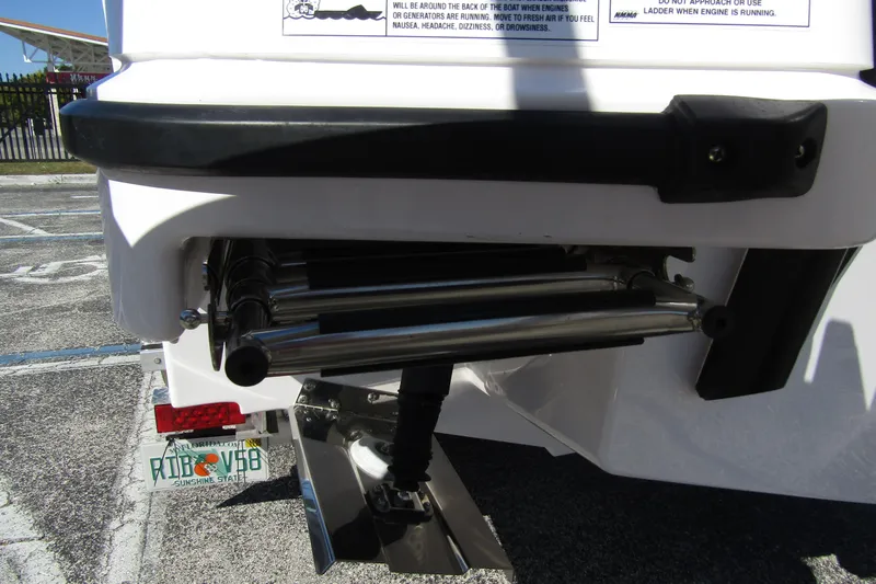 Slide: The Image of Rear view of 2024 Axopar 25 Cross Top boat with ladder and license plate. - 2