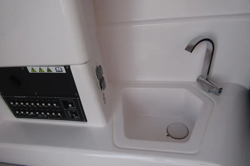 Slide: The Image of 2024 Axopar 25 Cross Top boat interior sink and control panel. - 20