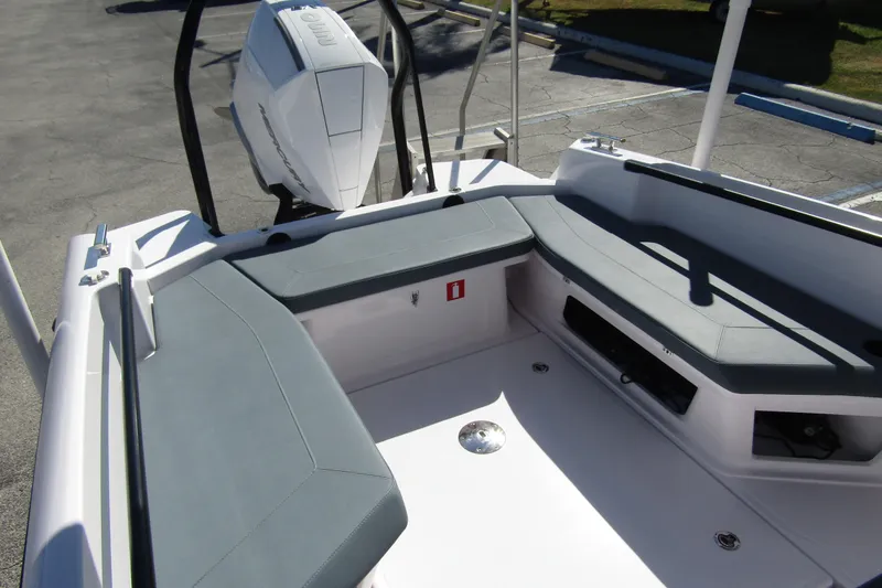 Slide: The Image of 2024 Axopar 25 Cross Top boat interior with seating and outboard motor. - 24