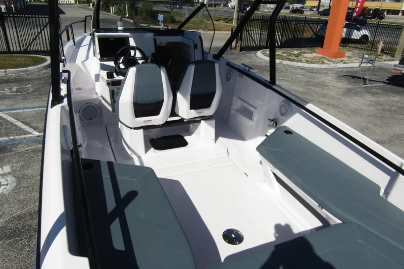 Slide: The Image of 2024 Axopar 25 Cross Top boat interior with seating and steering console. - 26