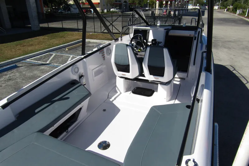 Slide: The Image of 2024 Axopar 25 Cross Top boat interior with modern seating and sleek design. - 27
