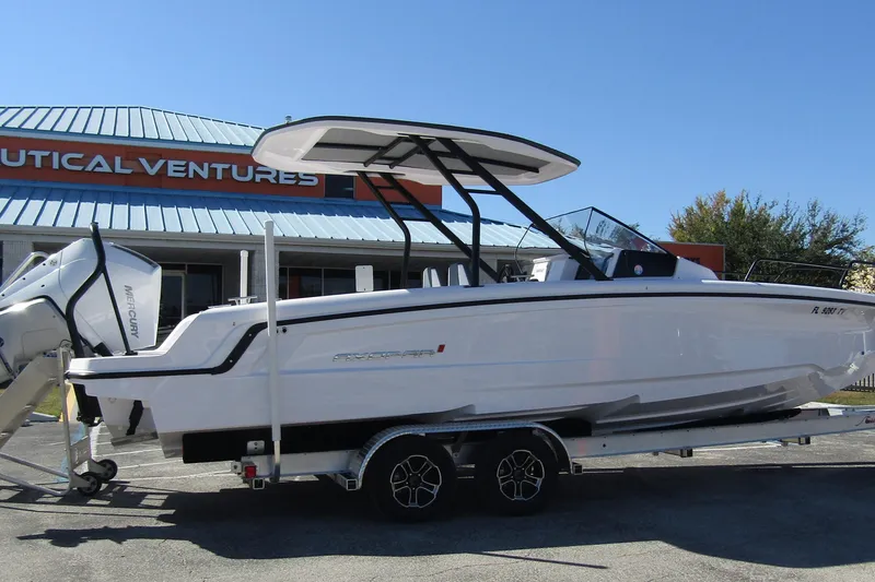 Slide: The Image of 2024 Axopar 25 Cross Top boat on trailer at Nautical Ventures dealership. - 3