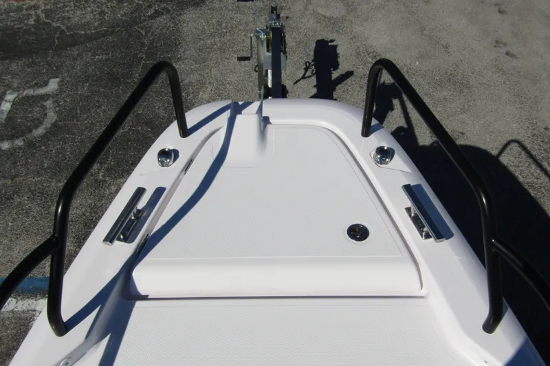 Slide: The Image of 2024 Axopar 25 Cross Top boat deck with black railings and sleek design. - 7