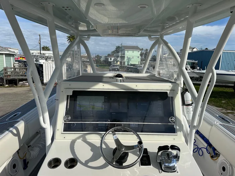 Slide: The Image of 2011 SeaHunter Center Console boat dashboard with steering wheel and navigation system. - 2