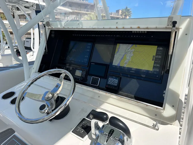 Slide: The Image of 2011 SeaHunter Center Console boat dashboard with navigation screens and steering wheel. - 3