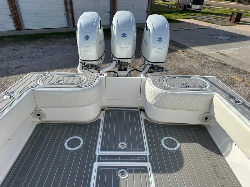 Slide: The Image of 2011 SeaHunter Center Console boat with triple outboard engines and spacious deck. - 6