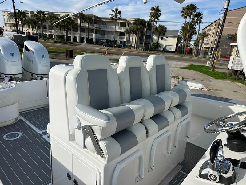 Slide: The Image of 2011 SeaHunter Center Console boat with cushioned seating and dual outboard motors. - 8