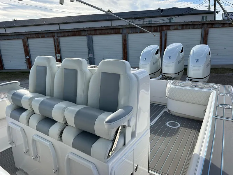 Slide: The Image of 2011 SeaHunter Center Console boat with quad engines and cushioned seating. - 9