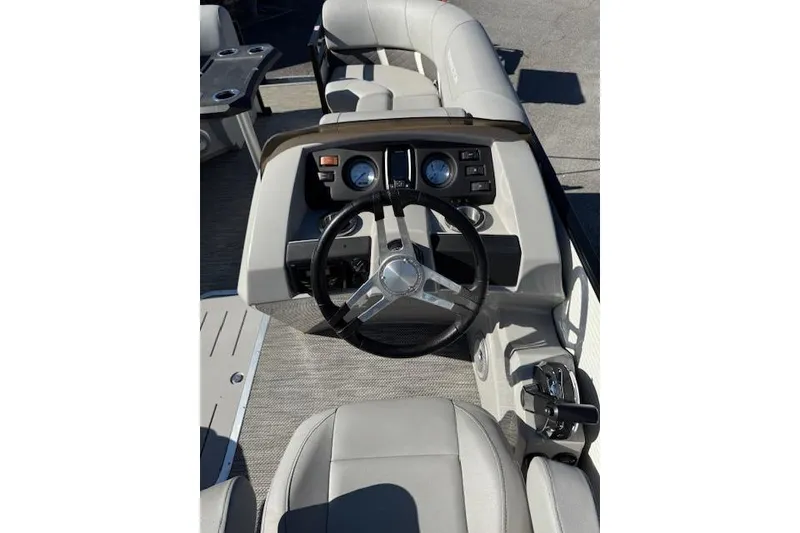 Slide: The Image of 2023 Bennington 22SX boat interior with steering wheel and dashboard controls. - 10
