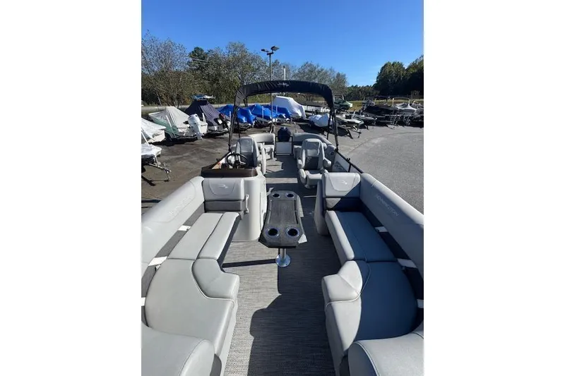 Slide: The Image of 2023 Bennington 22SX pontoon boat with spacious seating and modern design. - 5