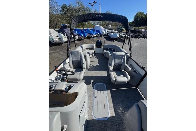 Slide: The Image of 2023 Bennington 22SX pontoon boat with spacious seating and modern design. - 6