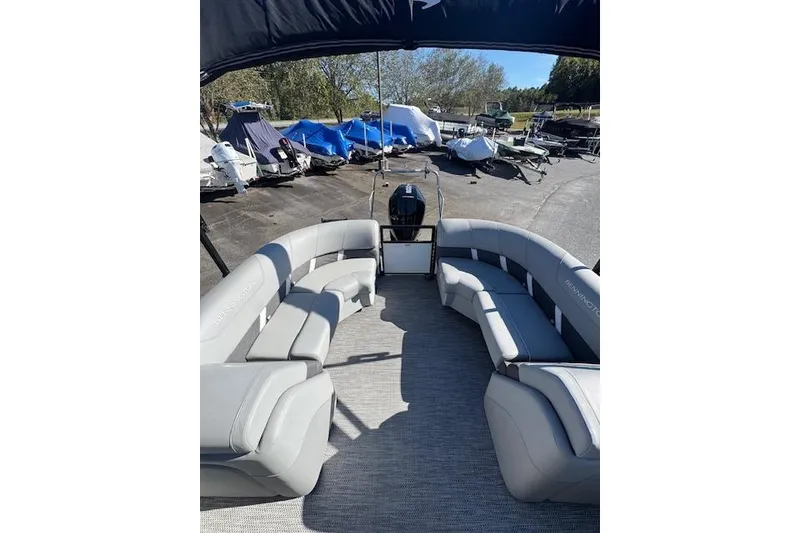 Slide: The Image of 2023 Bennington 22SX pontoon boat with spacious seating and modern design. - 7