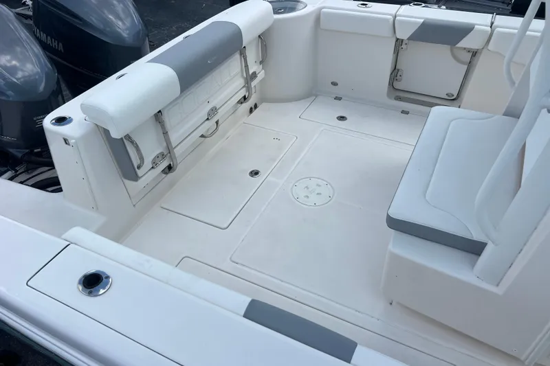 Slide: The Image of 2020 Robalo R302 Center Console boat interior with seating and storage compartments. - 17