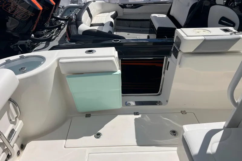 Slide: The Image of 2020 Robalo R302 Center Console boat interior with seating and storage compartments. - 19