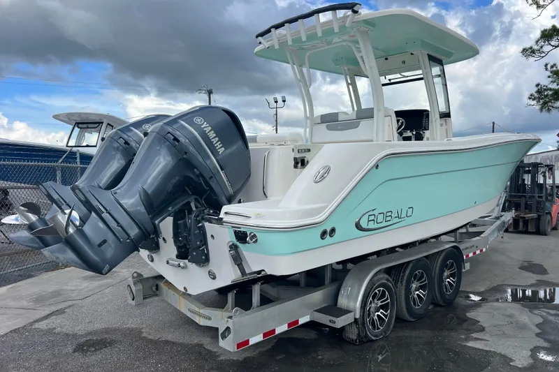 Slide: The Image of 2020 Robalo R302 Center Console boat with Yamaha engines on a trailer. - 4