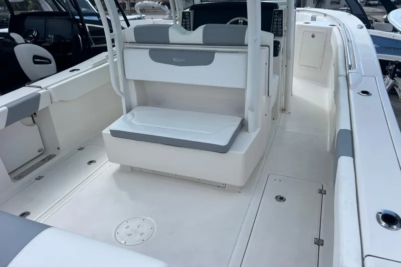 Slide: The Image of 2020 Robalo R302 Center Console boat interior with seating and console area. - 8