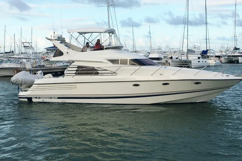 The Image of 1997 Sunseeker Manhattan 48 yacht docked in marina, surrounded by other boats. - 1