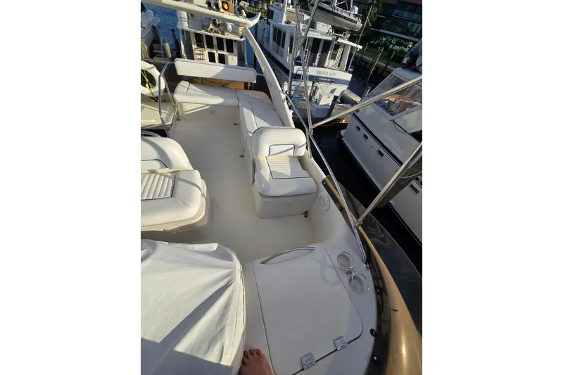 Slide: The Image of 1997 Sunseeker Manhattan 48 yacht deck with white seating and marina view. - 11