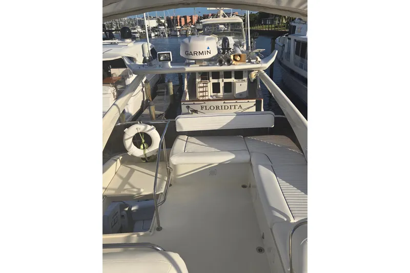 Slide: The Image of 1997 Sunseeker Manhattan 48 yacht docked, featuring spacious deck and Garmin equipment. - 12