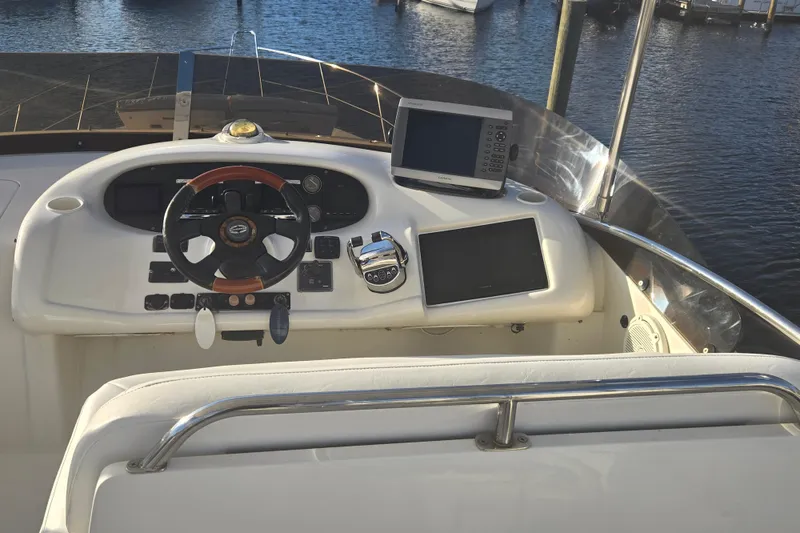 Slide: The Image of Cockpit of 1997 Sunseeker Manhattan 48 yacht with steering wheel and navigation equipment. - 13