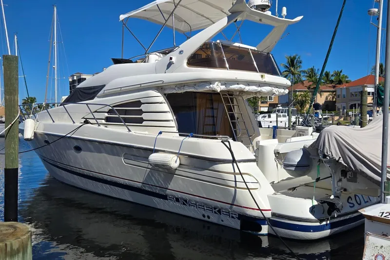 Slide: The Image of 1997 Sunseeker Manhattan 48 yacht docked in a marina, featuring sleek design and luxury amenities. - 2