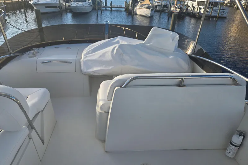 Slide: The Image of Sunseeker Manhattan 48 yacht interior, 1997 model, docked at marina with covered seating area. - 27