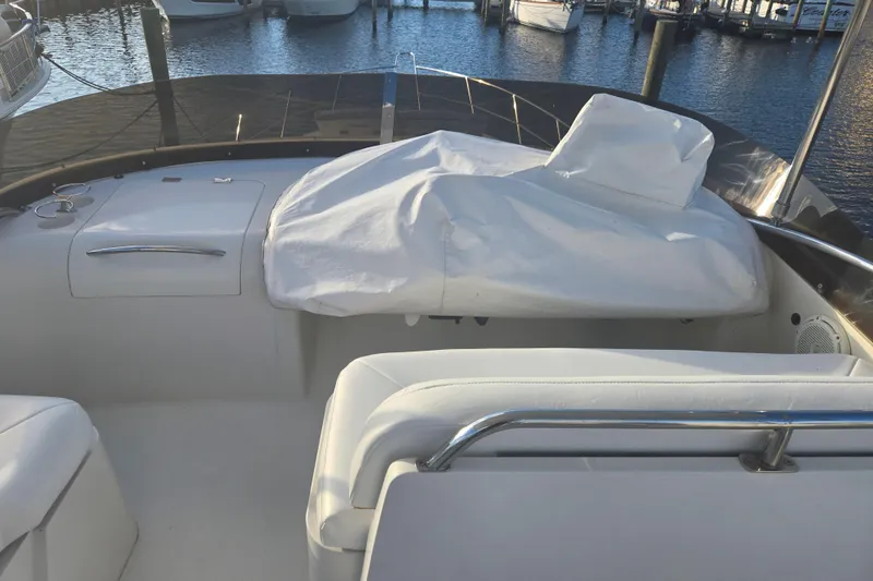 Slide: The Image of 1997 Sunseeker Manhattan 48 yacht deck with covered seating, docked at marina. - 28