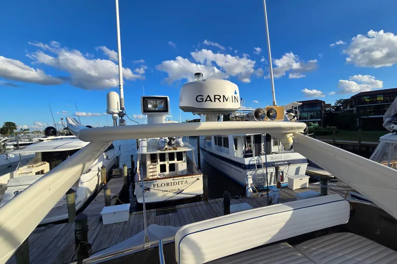 Slide: The Image of Sunseeker Manhattan 48 yacht docked, featuring Garmin equipment, under a clear blue sky. - 29