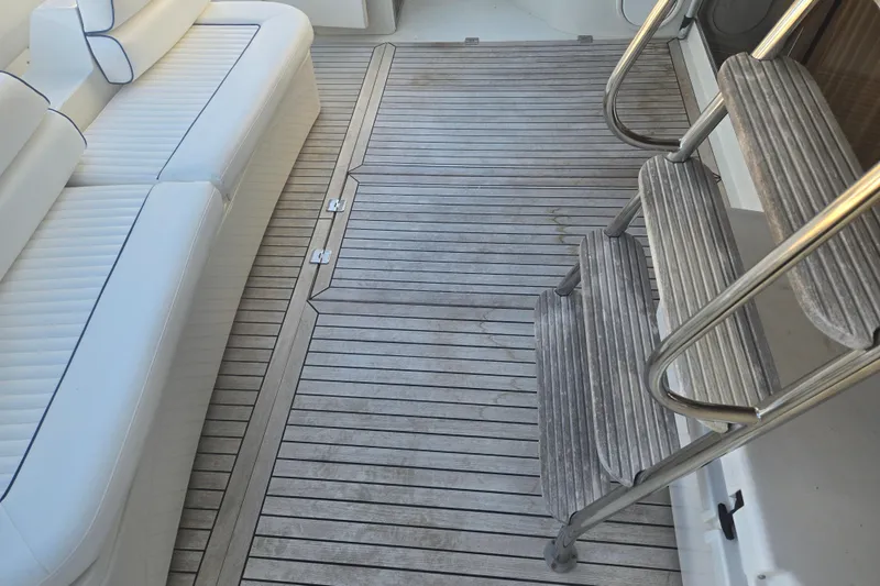 Slide: The Image of 1997 Sunseeker Manhattan 48 yacht interior with white seating and wooden flooring. - 33