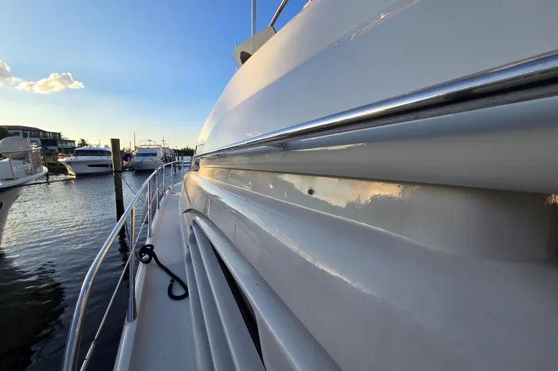 Slide: The Image of 1997 Sunseeker Manhattan 48 yacht docked at marina, side view at sunset. - 38