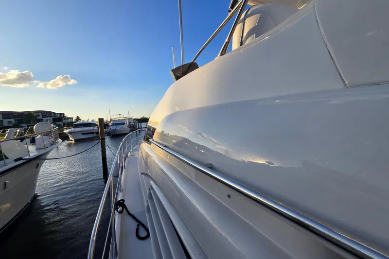 Slide: The Image of Sunseeker Manhattan 48 yacht docked at marina, reflecting sunset light, 1997 model. - 39
