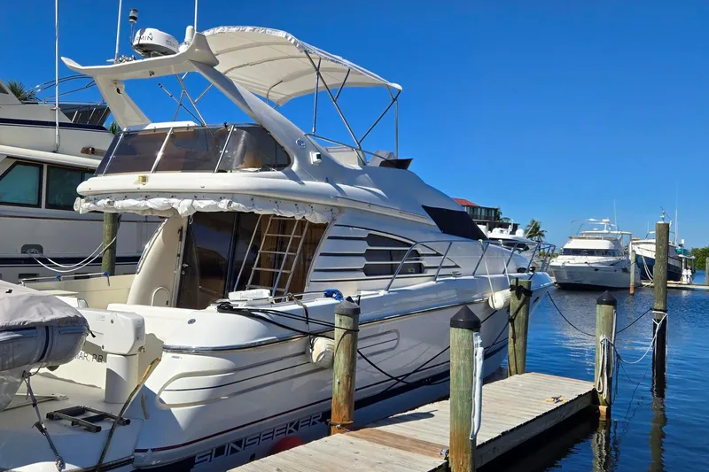 Slide: The Image of 1997 Sunseeker Manhattan 48 yacht docked at marina under clear blue sky. - 4