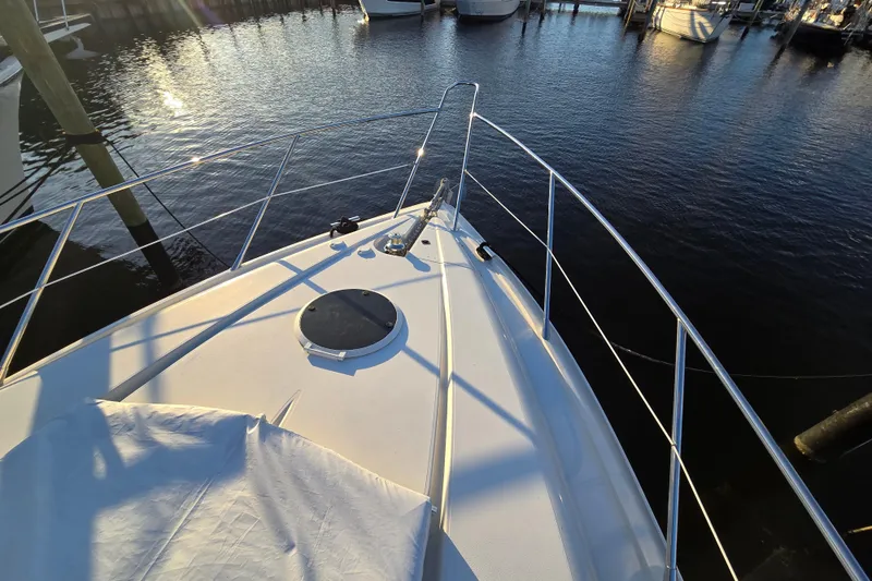 Slide: The Image of Bow of 1997 Sunseeker Manhattan 48 yacht docked in marina at sunset. - 40