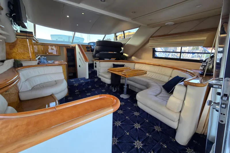 Slide: The Image of Luxurious interior of a 1997 Sunseeker Manhattan 48 yacht with elegant seating and wood accents. - 48