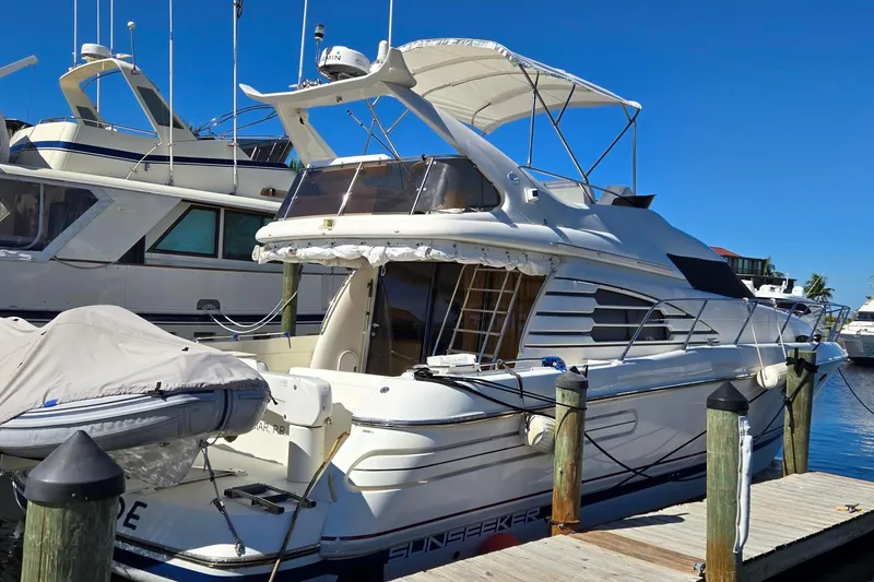 Slide: The Image of 1997 Sunseeker Manhattan 48 yacht docked at marina under clear blue sky. - 5