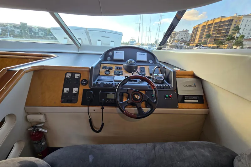 Slide: The Image of Interior helm of 1997 Sunseeker Manhattan 48 yacht with navigation controls and steering wheel. - 51