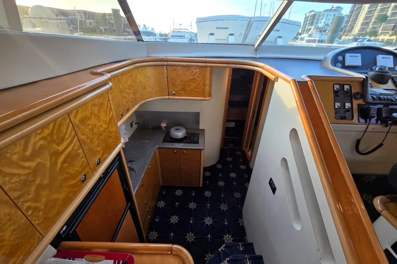 Slide: The Image of Interior of 1997 Sunseeker Manhattan 48 yacht with wood cabinetry and modern amenities. - 53