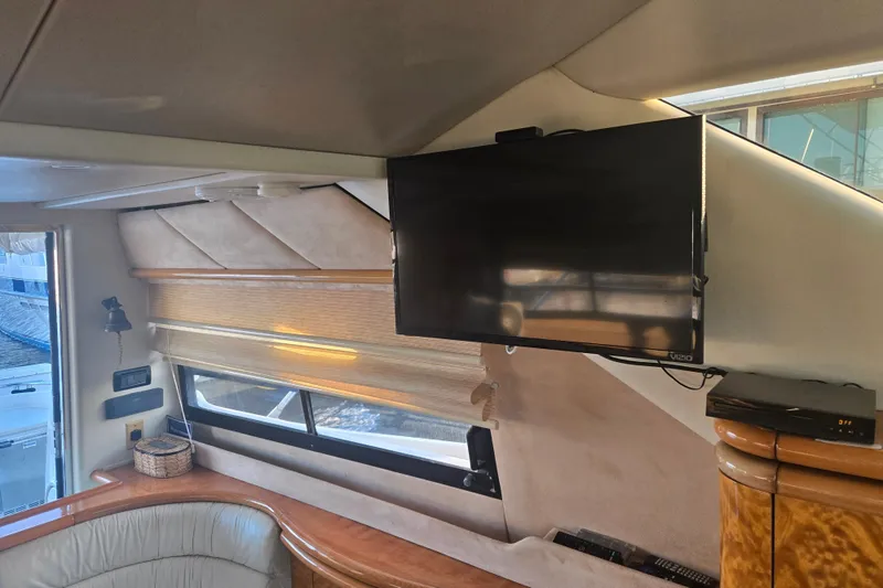 Slide: The Image of Interior of 1997 Sunseeker Manhattan 48 yacht with mounted TV and window view. - 57